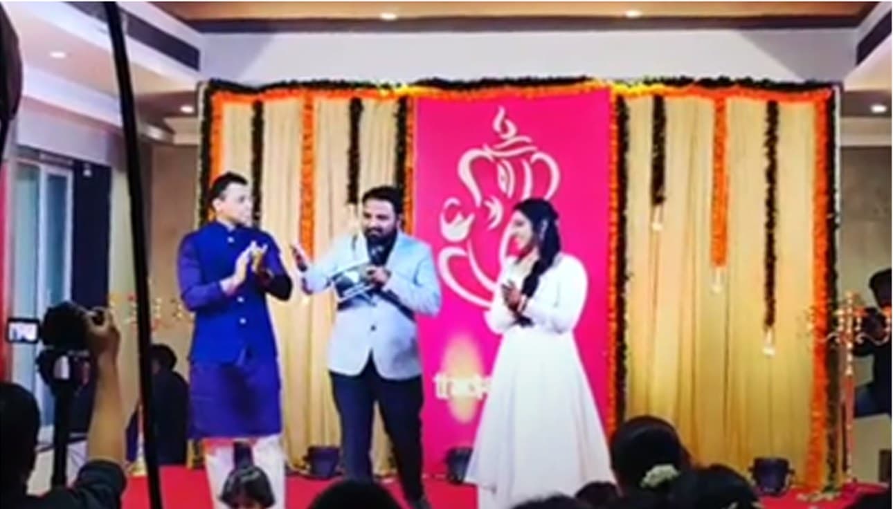 Anchor Akash Phalle hosting a sangeet ceremony with family members on stage